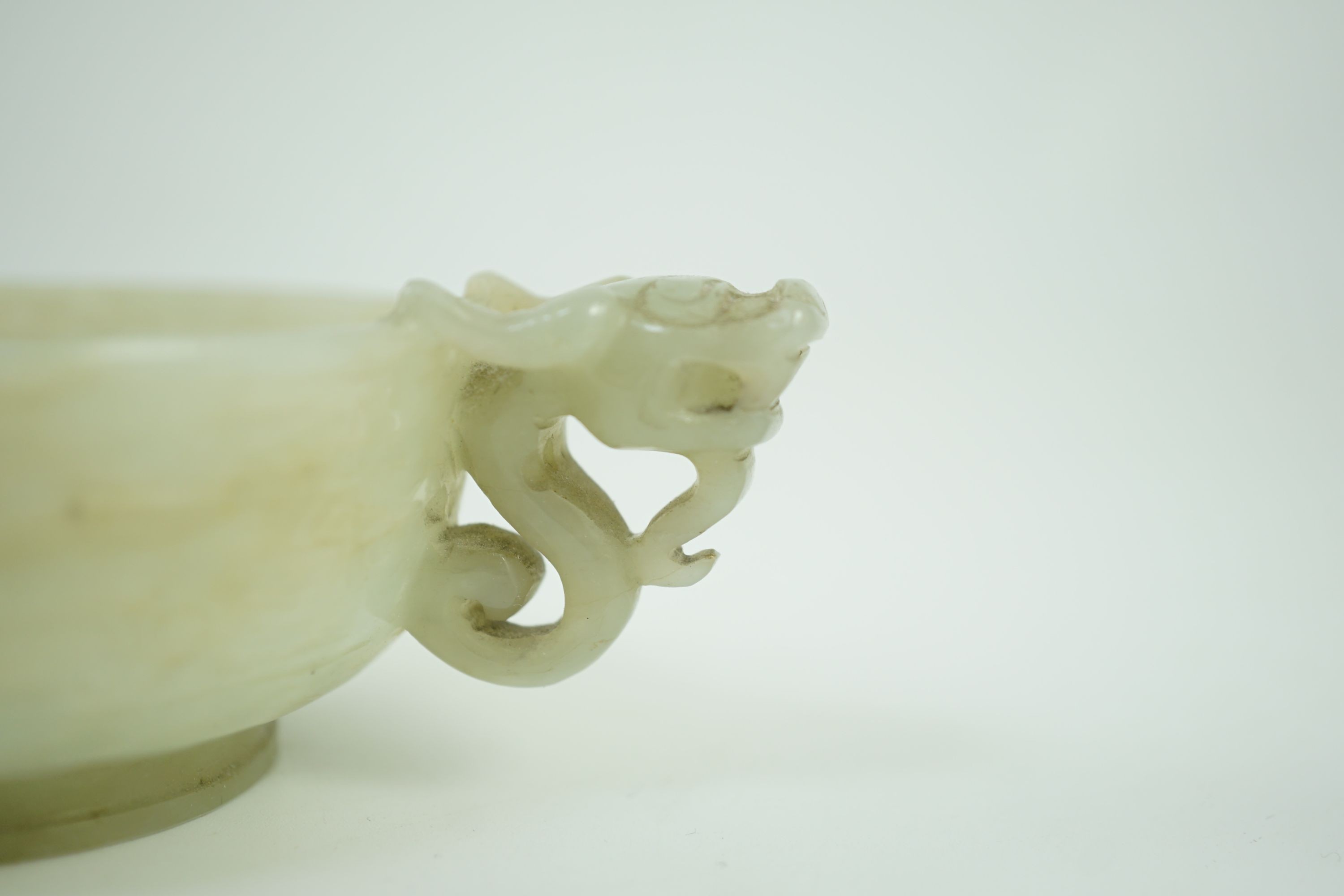 A Chinese pale celadon jade two handled ‘chilong’ cup, 17th/18th century, 13.2cm wide